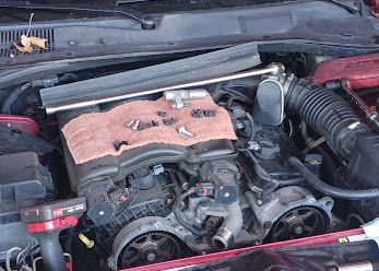 Engine with the intake removed and parts laid out on a towel
