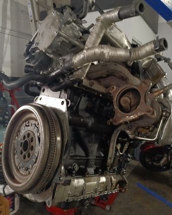 Engine pulled out of a car and hanging from a hoist