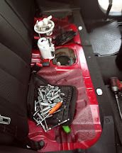 Fuel pump removed through the access panel under a rear seat